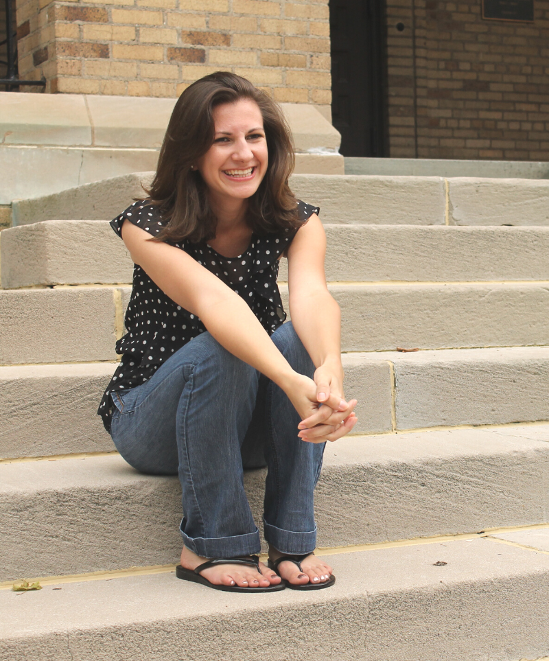 woman sitting outside on steps happy smiling